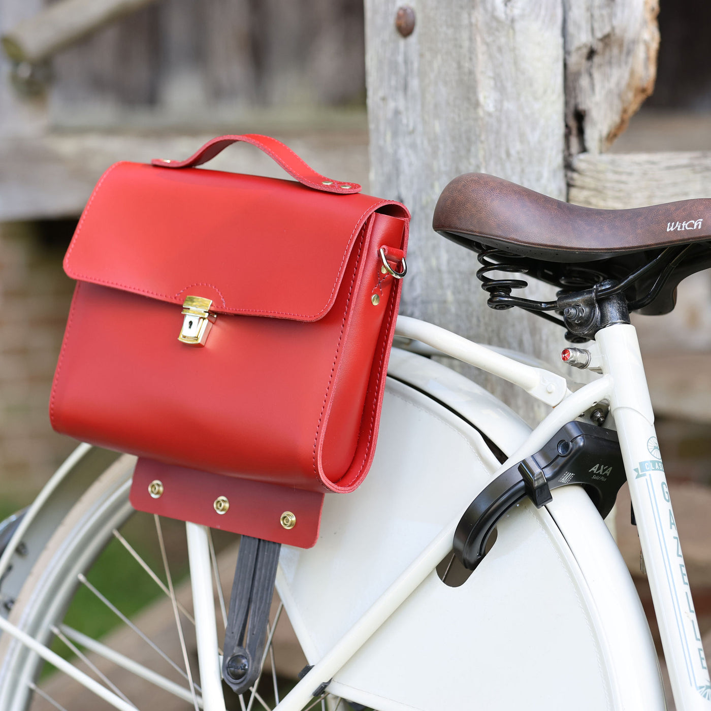 Picture of women's stylish bike bags in the  style of red, tan and aqua leather satchel bike bags