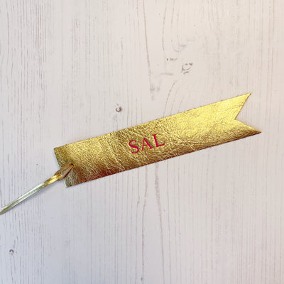 Picture of British-made sustainable gold leather bookmark with free personalisation, personalised leather gifts UK, gold bookmark 
