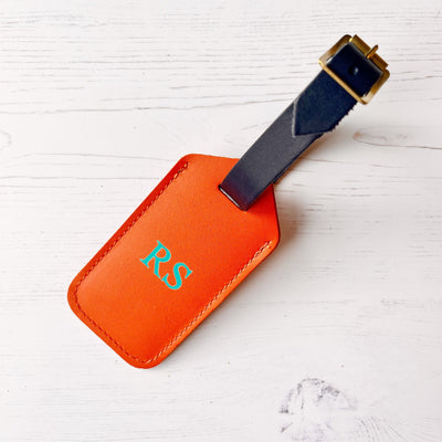 Picture of orange leather luggage tag, personalised luggage tag UK, personalised British leather luggage tag.