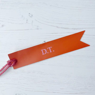 Picture of British-made sustainable orange leather bookmark with free personalisation, personalised leather gifts UK, orange bookmark 