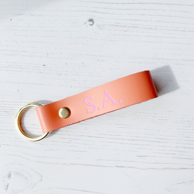 Picture of British-made sustainable salmon pink leather keyring with free personalisation, personalised leather gifts UK, salmon pink keyring 