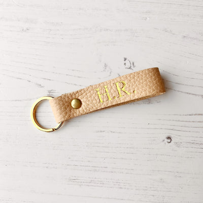 Picture of British-made sustainable seashell cream leather keyring with free personalisation, personalised leather gifts UK, seashell cream keyring 