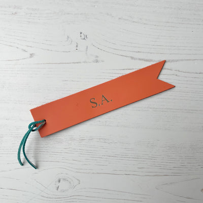 Picture of British-made sustainable salmon pink leather bookmark with free personalisation, personalised leather gifts UK, salmon pink bookmark 