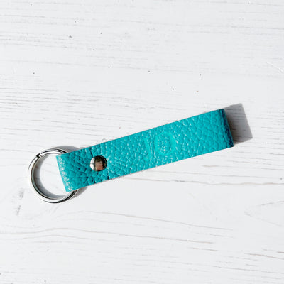 Picture of British-made sustainable teal leather keyring with free personalisation, personalised leather gifts UK, teal keyring 