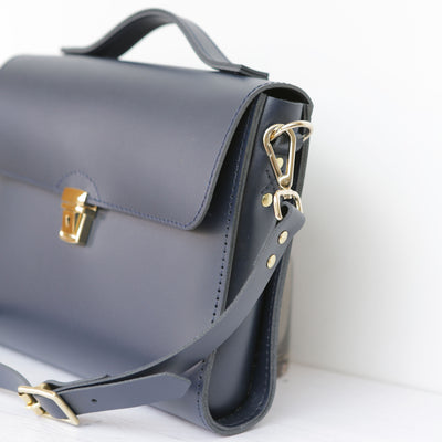 Picture of women's stylish bike bag in the style of a navy leather satchel bike bag