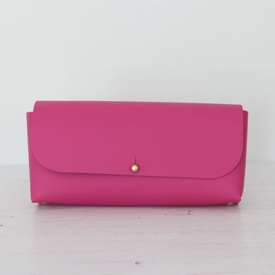 Picture of raspberry pink leather crossbody bag, crossbody bag with chain, small leather saddle bag, leather handlebar bag